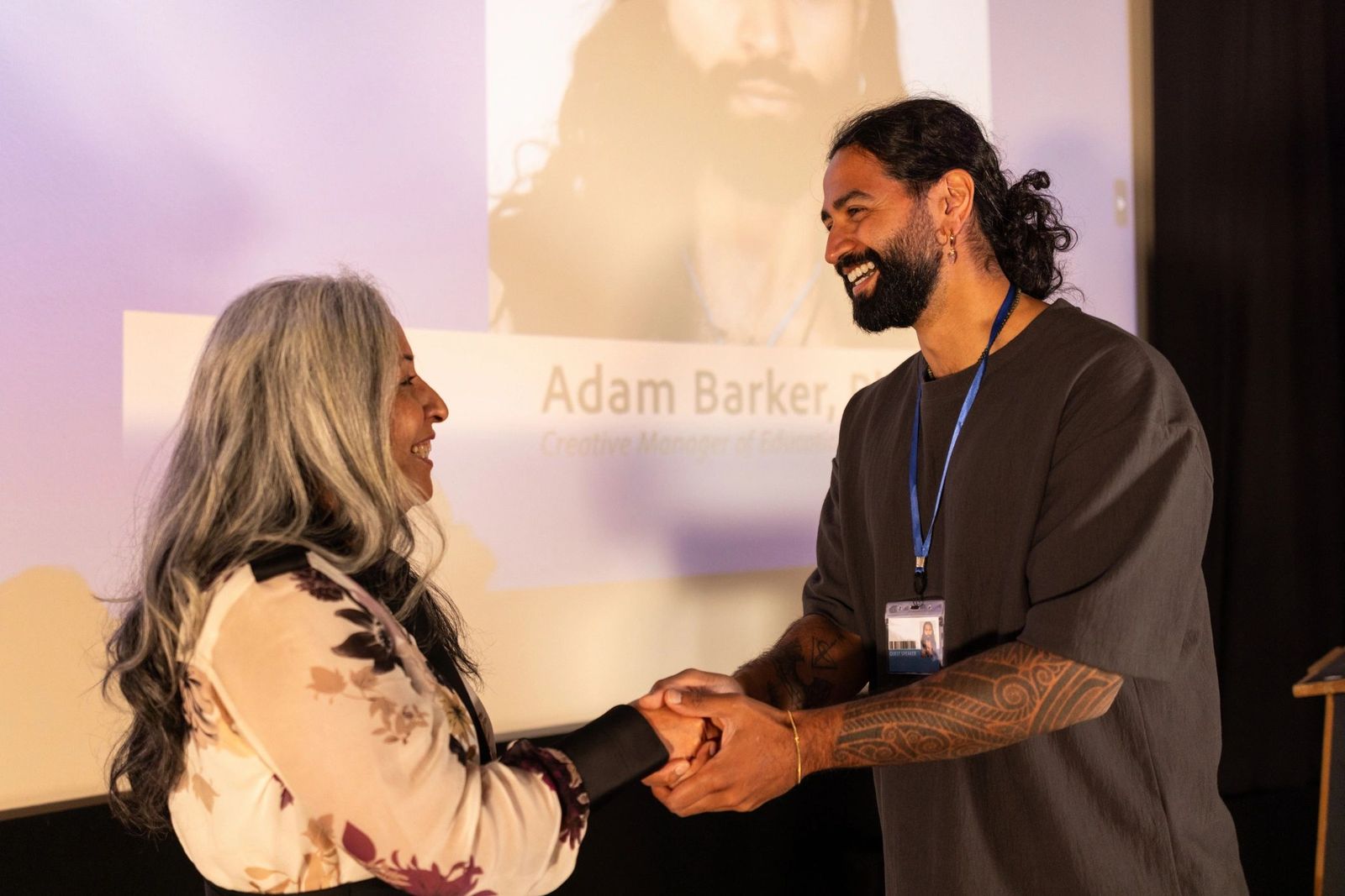 Community leaders greeting each other on stage