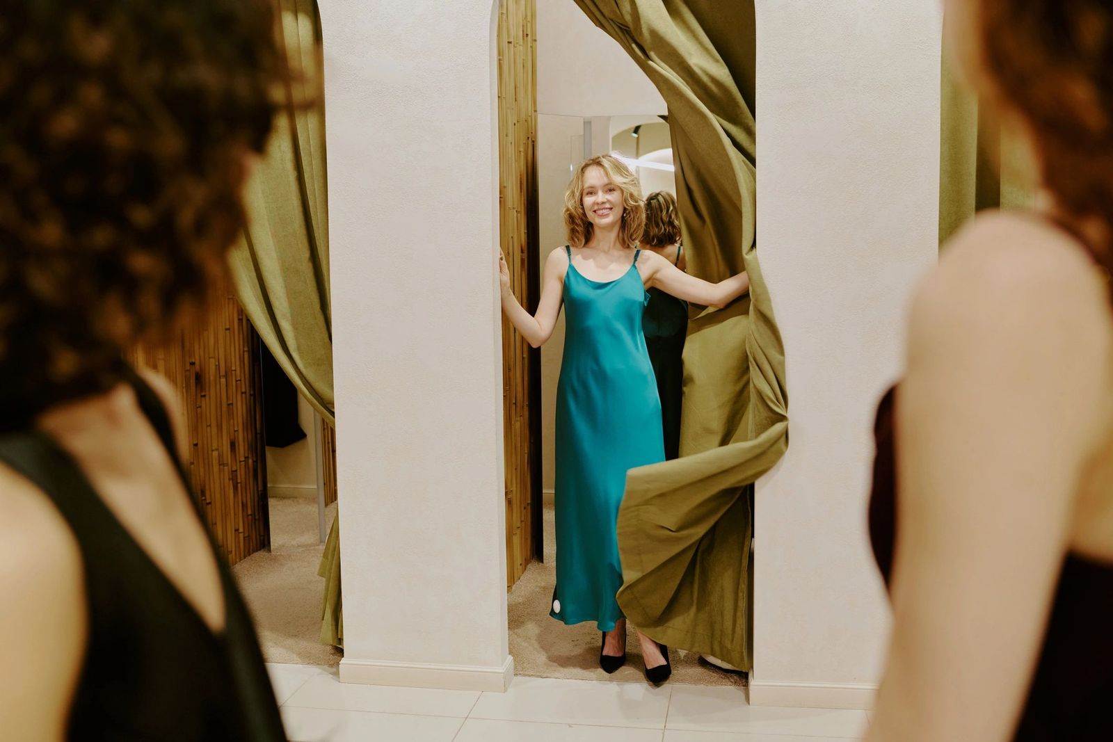 Model presenting a teal satin gown