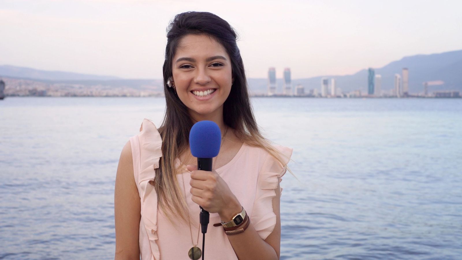 Presenter holding a microphone on location